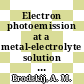 Electron photoemission at a metal-electrolyte solution interface /